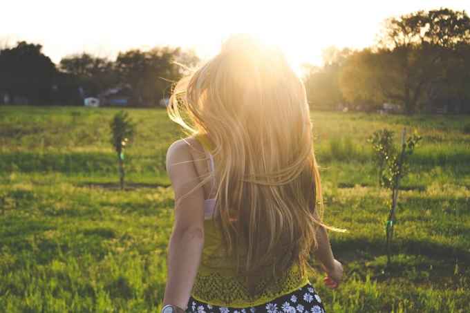 girl running in sunny field